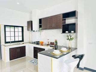 Modern Kitchen with White Interior and Dark Cabinets