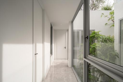 Modern corridor with natural light and garden view