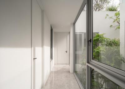 Modern corridor with natural light and garden view