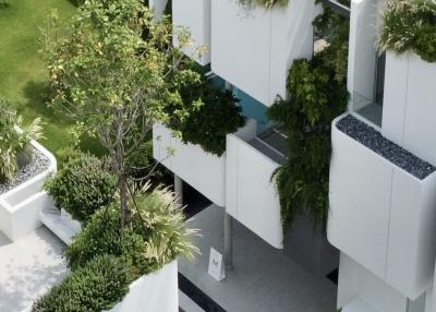 Modern apartment complex with lush rooftop gardens