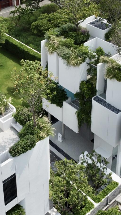 Modern apartment complex with lush rooftop gardens