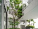 Modern building exterior with abundant greenery and glass facade