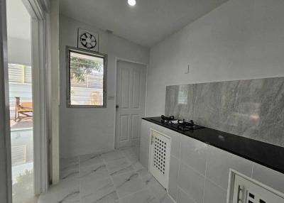 Modern kitchen with black countertops and tiled floor