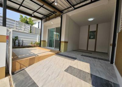Spacious modern patio with patterned floor tiles and sheltered roofing