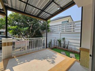 Spacious covered patio with a view of the garden and external fence