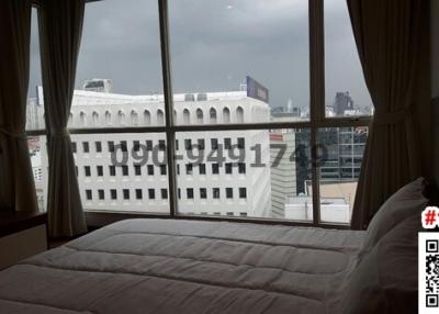 Cozy bedroom with large window and city view