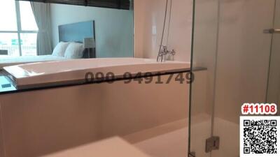 Modern bathroom with glass shower and bedroom view