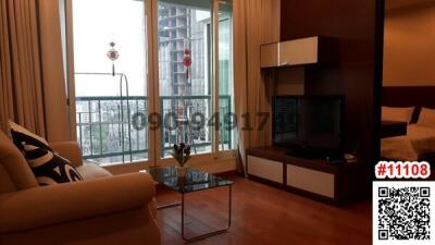 Modern furnished living room with balcony access and city view