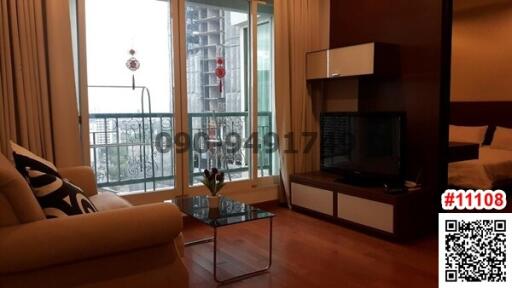 Modern furnished living room with balcony access and city view