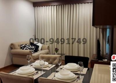 Elegant dining room with a set table, contemporary furniture and a comfortable sitting area