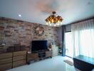 Elegant living room with wooden accent wall and ornate chandelier