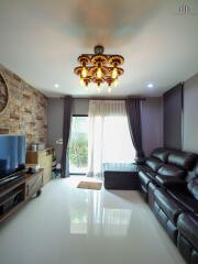 Elegant living room with stone accent wall and modern chandelier