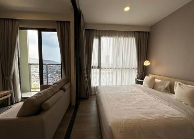 Spacious bedroom with large windows and a scenic view