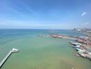 Scenic oceanfront view from apartment, showcasing clear blue sky, waterfront, and boats