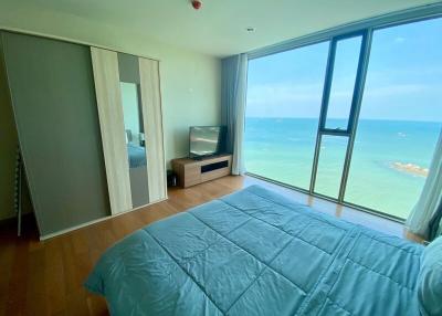 Ocean view bedroom with large windows and minimalist decor
