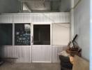 Unfinished interior space with sliding doors and corrugated metal walls