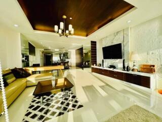 Spacious and modern living room with natural stone wall and sleek furnishings