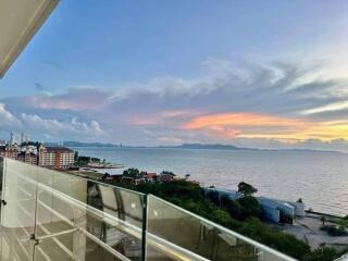 Panoramic ocean view from high-rise balcony at sunset