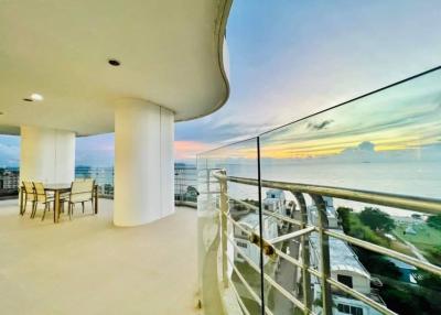 Spacious balcony with panoramic ocean view and seating area