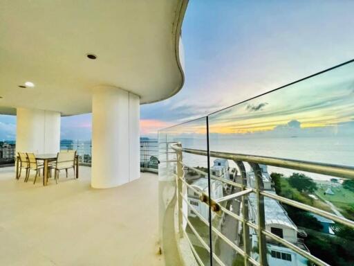 Spacious balcony with panoramic ocean view and seating area