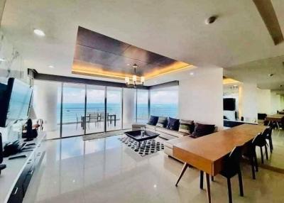 Spacious living room with ocean view, modern furnishings, and open floor plan
