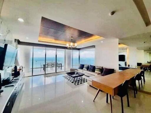 Spacious living room with ocean view, modern furnishings, and open floor plan
