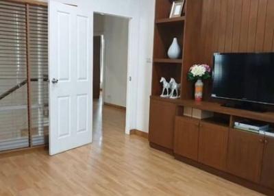 Spacious living room with wooden flooring and storage cabinets