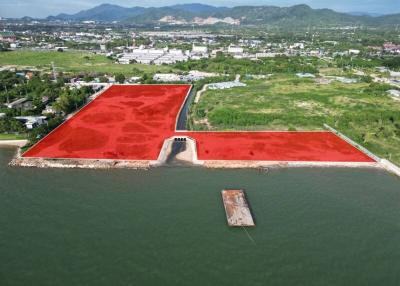 Aerial view of large waterfront area with red soil