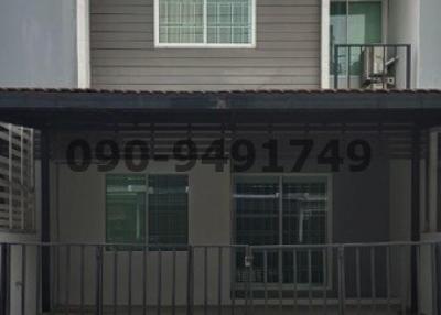 Two-story residential building with balcony and gated entrance