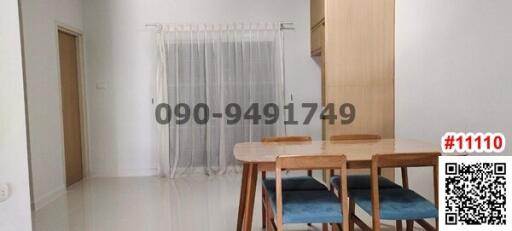 Bright dining area with wooden table and modern chairs