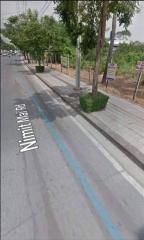 Street view with trees and sidewalk next to a road