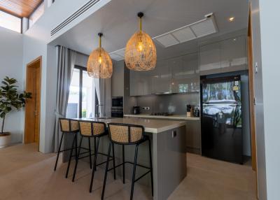Modern kitchen with bar stools and decorative pendant lights