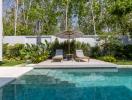 Stylish backyard with pool, sun loungers, and lush garden
