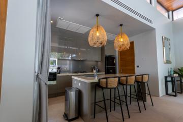 Modern kitchen interior with island and elegant pendant lights