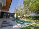 Luxurious private pool alongside modern villa with lush greenery