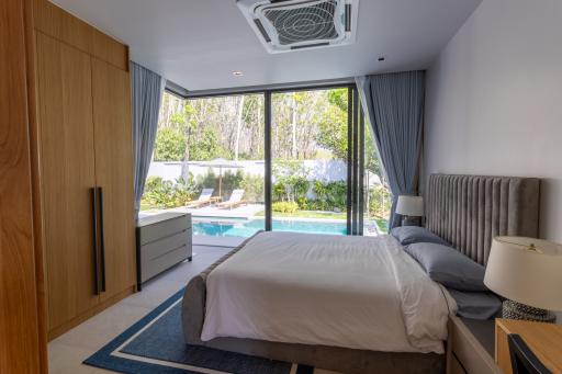 Modern bedroom with direct pool access and natural light