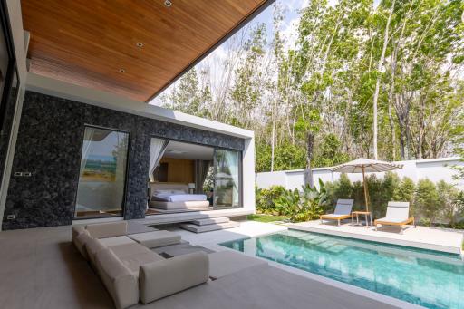Modern outdoor pool area with direct bedroom access and lounging chairs