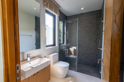 Modern bathroom interior with walk-in shower and natural light