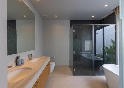 Spacious modern bathroom with dual vanities and freestanding bathtub
