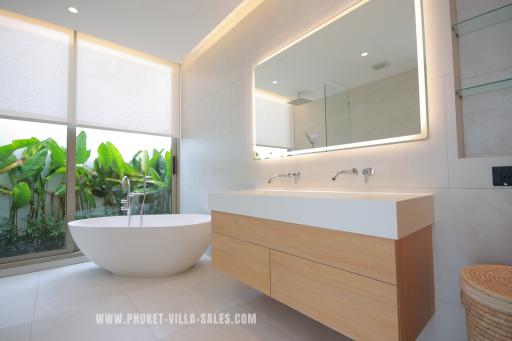 Modern bathroom with freestanding tub and large mirror
