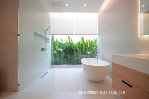 Modern bathroom with freestanding tub and natural view