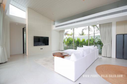 Spacious and modern living room with high ceilings and ample natural light