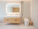 Modern bathroom with bright lighting, floating vanity, and mirrored cabinet
