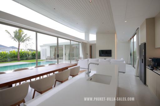 Spacious and modern living room with open plan design featuring pool view