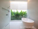Modern Bathroom with Freestanding Tub and Garden View