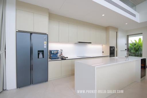 Modern kitchen with stainless steel appliances and white minimalist cabinets