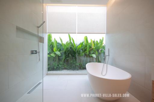 Modern bathroom with freestanding tub and natural outdoor view