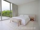 Minimalist bedroom with large glass door opening to an exterior view