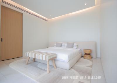 Modern minimalist bedroom with clean design and ample lighting
