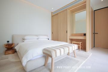 Spacious modern bedroom with king-sized bed and wooden accents